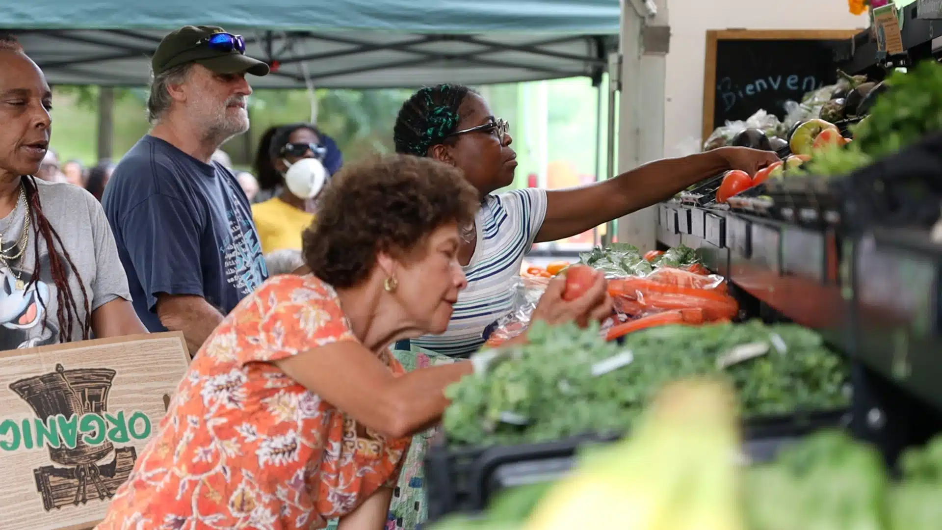 People grabbing fresh produce from the Farmers Market Truck, Asheville NC