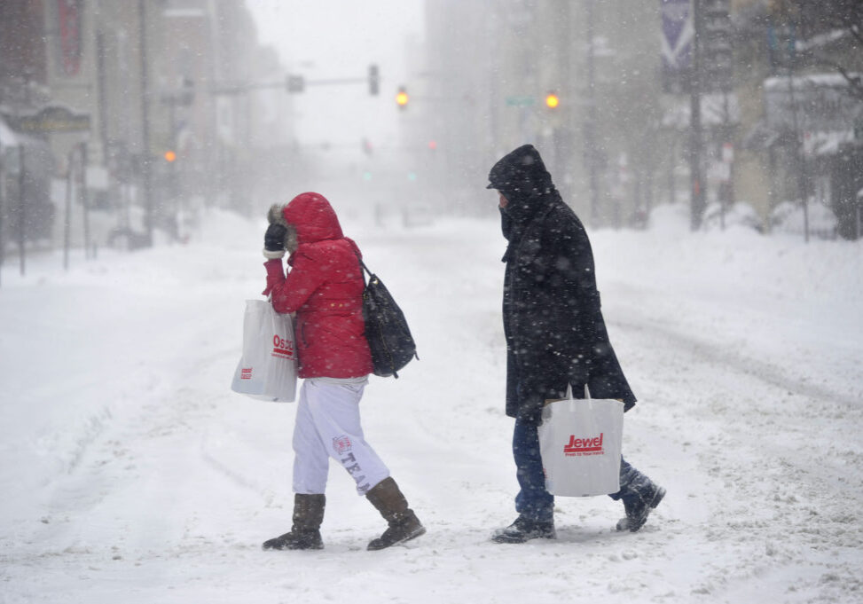 Pedestrians cope with blowing snow as they walk through downtown Chicago on February 2, 2011. An overnight storm caused school closures, snarled traffic and dumped 17 inches of snow on much of the Chicago area with another 4 to 8 inches expected before afternoon.       UPI/Brian Kersey