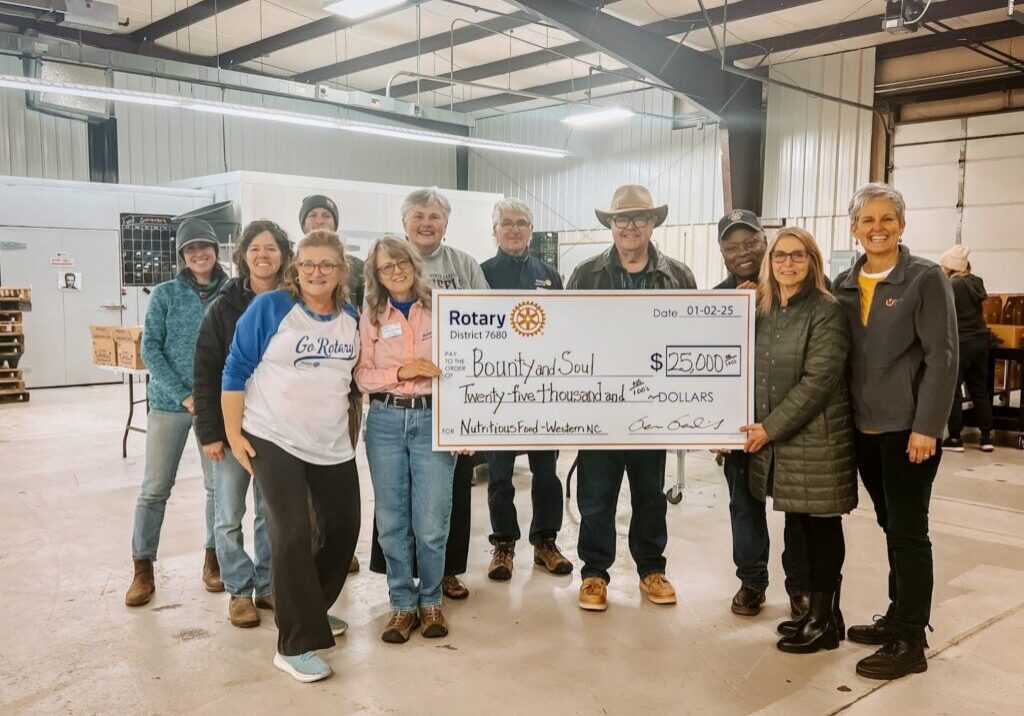 Fox Carolina news segment featuring Bounty & Soul's $25,000 donation from Rotary District 7680 to support communities impacted by Hurricane Helene. The check presentation is shown with a news anchor and representatives from Rotary and Bounty & Soul.